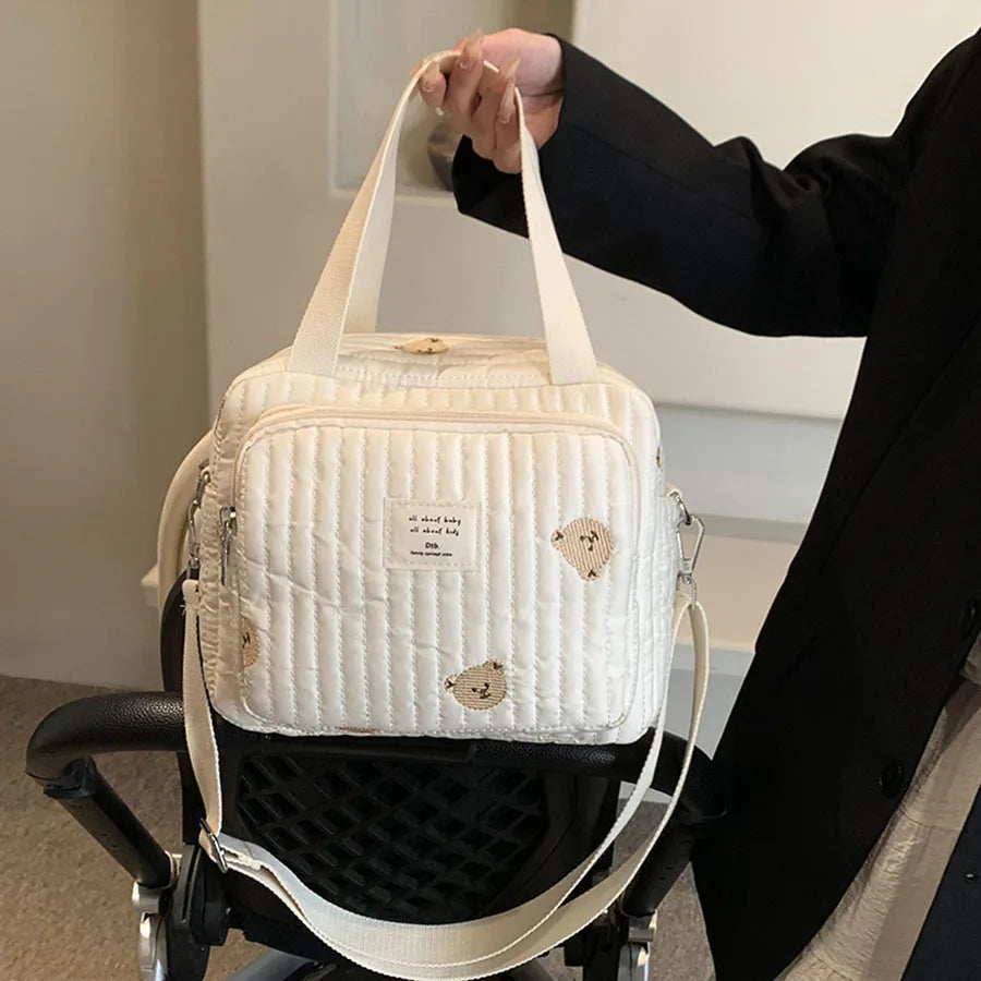 Versatile Quilted Diaper Bag with Embroidered Animal Prints, Ideal for Stroller Attachment and On-the-Go Use