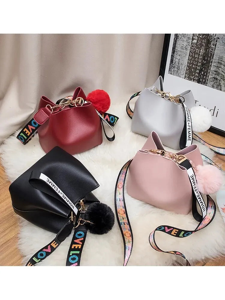 Fashionable Bucket Bag for Women with Multicolor LOVE Strap and Pom Pom Charm