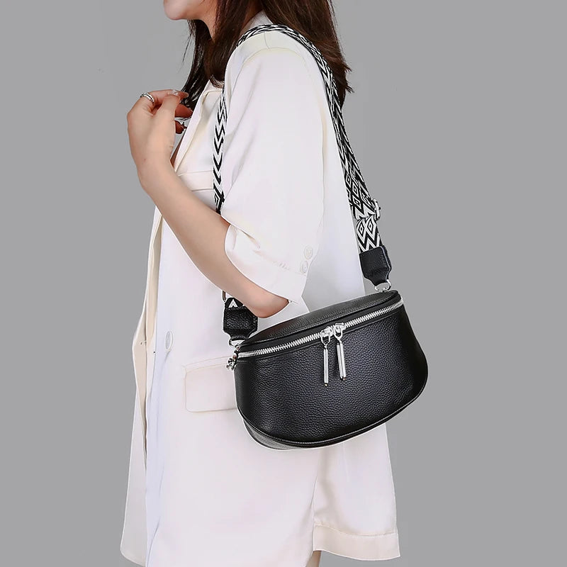 Sleek Leather Saddle Bag with Dual Zippers and Geometric Pattern Strap