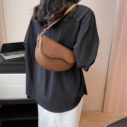 Modern Curved Leather Satchel with Sleek Design and Adjustable Shoulder Strap